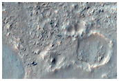 Pitted Material in Northern Rim of Lowell Crater