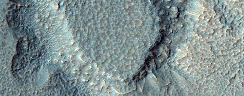 Monitor Slopes of Well-Preserved Crater in Aonia Terra
