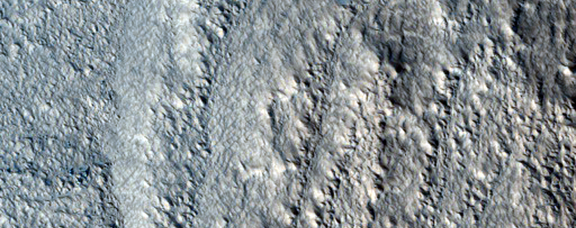Tongue-Shaped Flows on Moreux Crater Rim
