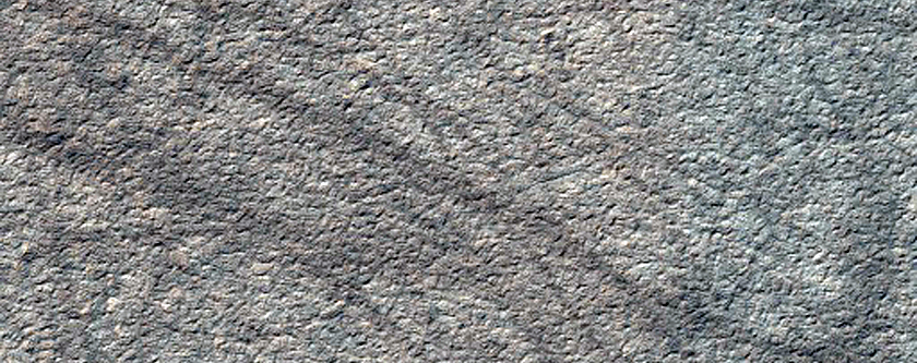 Circular Pit with Raised Irregular Ice Rings and Linear Tracks
