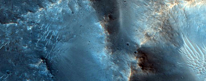 Possible Scoured Pitted Material and Bedrock on Floor of 65-Kilometer Crater
