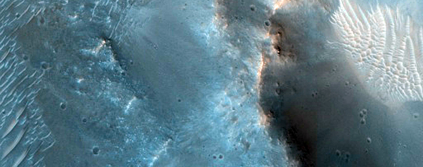 Possible Scoured Pitted Material and Bedrock on Floor of a 65-Kilometer Crater
