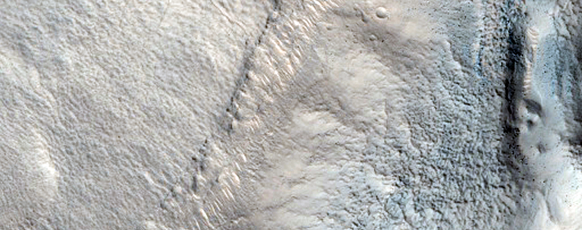Pits and Cracks in Crater in Protonilus Mensae
