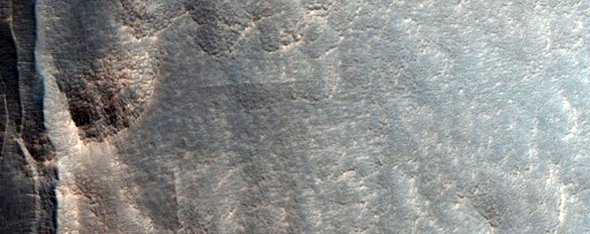 Pits and Cracks along Wall of Mid-Latitude Crater
