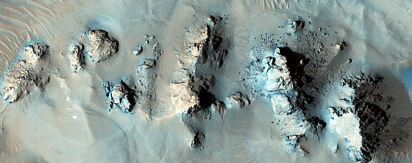Well-Exposed Pitted Materials and Breccias in Mojave Crater