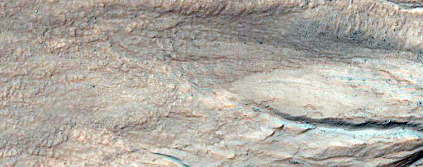 Eastern Portion of Gullied Impact Crater with Diverse Lithologies
