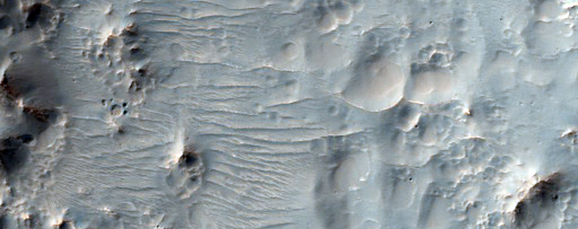 Hale Crater Ejecta with Pits and Rocky Outcrops
