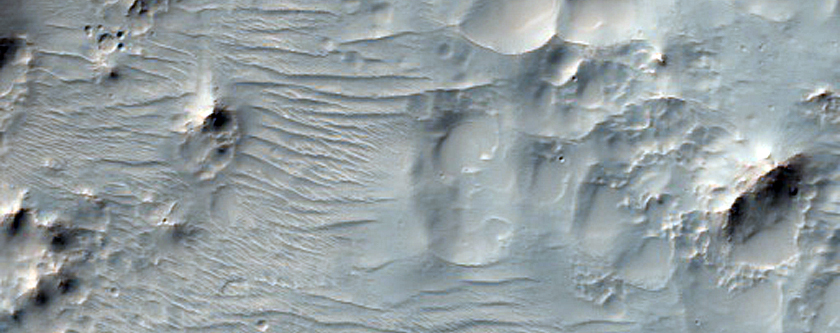 Hale Crater Ejecta with Pits and Rocky Outcrops
