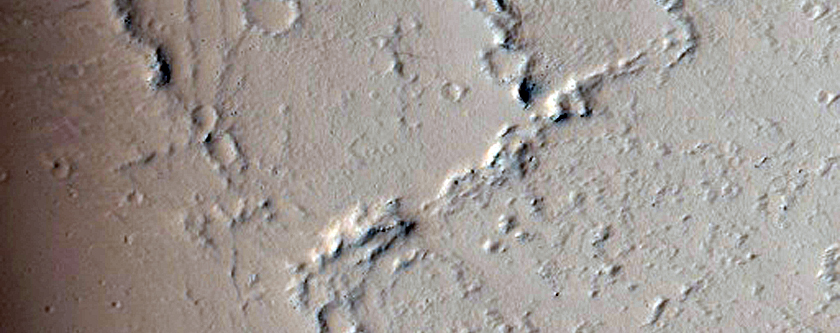 Flows and Crater Rim Southeast of Tharsis Tholus