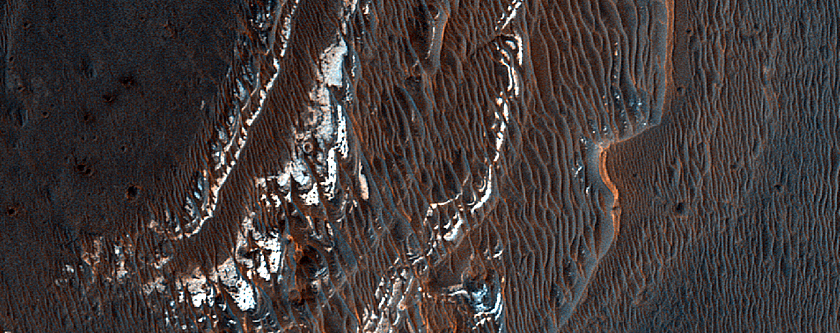 Layered Light-Toned Deposits on Floor of Orson Welles Crater