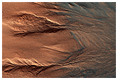 The Contrasting Colors of Crater Dunes and Gullies
