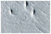 Curved Ridge-Trough Feature Near Zephyria Planum
