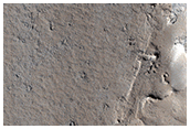 Flow Features Overlapping Crater Ejecta Deposit

