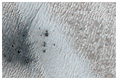 A New Crater on a Dusty Slope