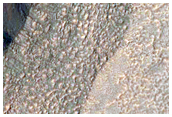 Western Portion of Gullied Impact Crater with Diverse Lithologies
