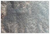 Pits and Cracks along Wall of Mid-Latitude Crater
