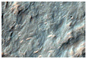 Exposed Breccia in Rim and Ejecta of Crater in Hesperia Planum
