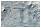Hale Crater Ejecta with Pits and Rocky Outcrops

