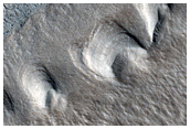 Raised Features with Circular Fronts in Tantalus Fossae
