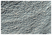 Crater on Ausonia Mensa with Ablated Ice and Channel
