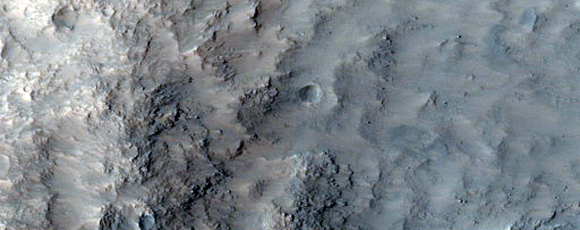 Crater with Central Uplift and Bedrock Outcrops in Walls
