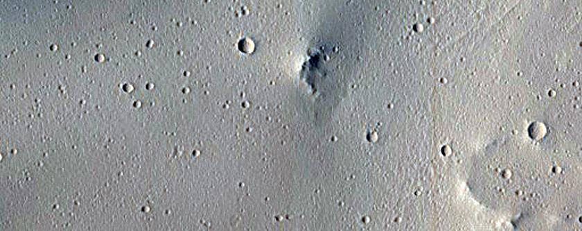 Crater Ejecta Crossing Trough in Tractus Fossae
