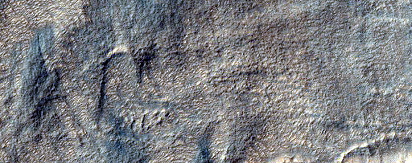 Crater with Fluvial Patterns in Harmakhis Vallis Plains
