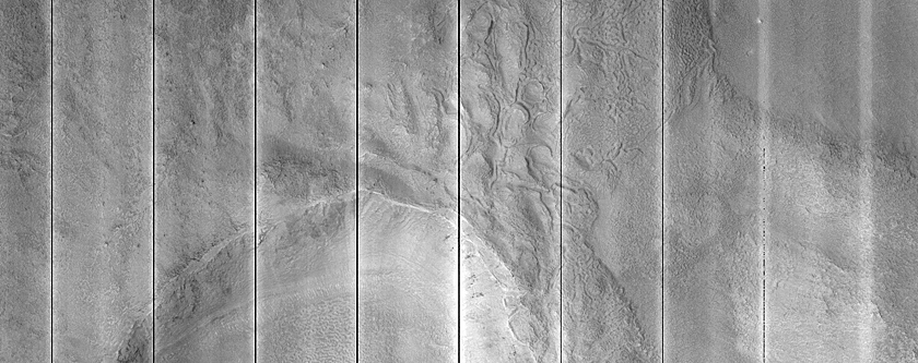 Pits and Cracks in Ejecta of Mid-Latitude Crater
