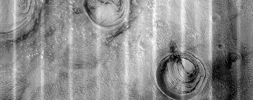 Layered Deposits in Three Craters in Northern Plains
