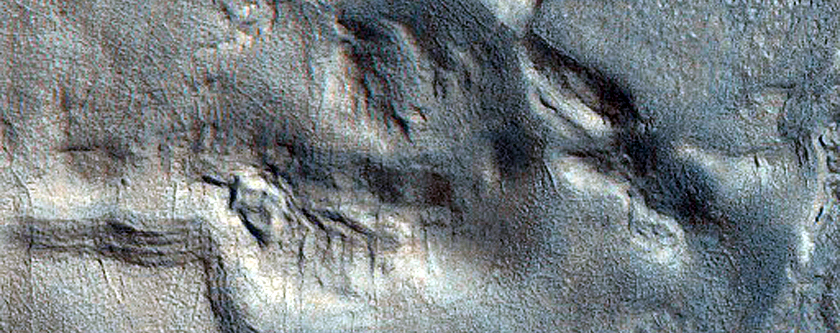 Surface Pits and Cracks in Phlegra Montes
