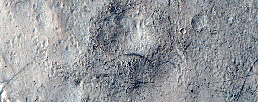 Dipping Layers along Rim of Crater Near Reull Vallis
