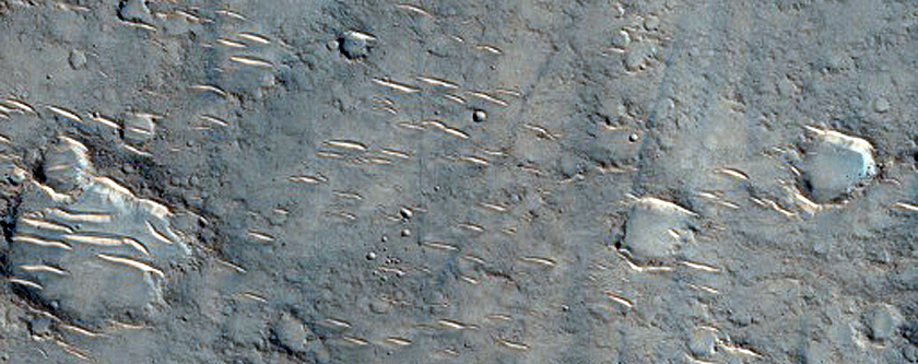 Channel Interacting with Small Crater in Hesperia Planum
