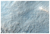 Fresh Small Impact Crater on Rim of Much Larger Crater
