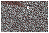 Small Ice-Filled Crater on North Polar Layered Deposits
