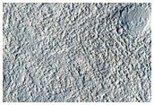 Crater in North Central Arabia Region with Stratified Floor Material in Pit

