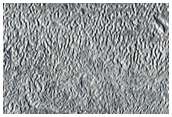 Elliptical Crater with Flow Features

