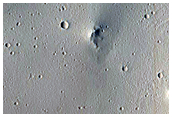 Crater Ejecta Crossing Trough in Tractus Fossae
