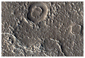 Channel and Infilled Crater Near Quenisset Crater
