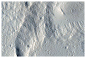 Layered Materials and Blocks in Olympus Mons Aureole
