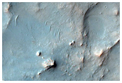 Possible Phyllosilicates in Eroded Terrain Near Channel
