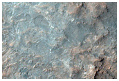 Layered Bedrock Exposure in Impact Crater

