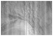 Pits and Cracks in Ejecta of Mid-Latitude Crater
