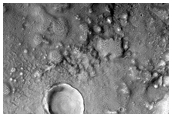 Layered Features in Craters in Northern Mid-Latitudes
