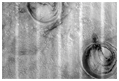 Layered Deposits in Three Craters in Northern Plains
