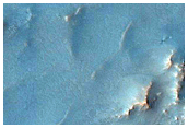 Large Well-Preserved Crater with Pitted Material in Charybdis Scopulus
