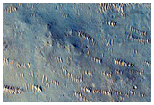 Fresh 1 to 2 Kilometer Impact Crater with Rocky Ejecta

