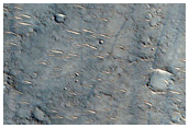 Channel Interacting with Small Crater in Hesperia Planum
