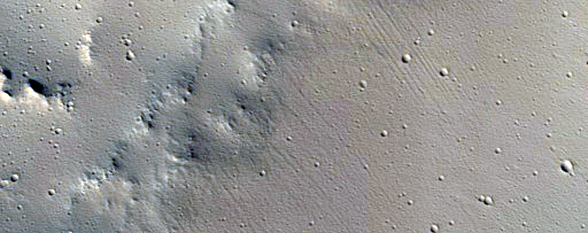 Crater Superposed on Trough
