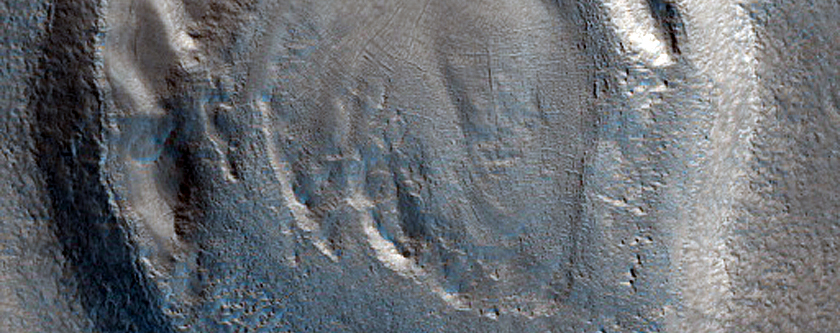 Dipping Layers in Crater in Northern Mid-Latitude Terrain
