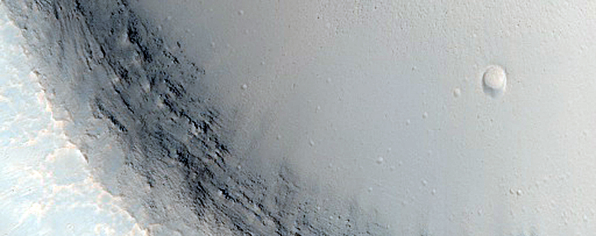 Crater South of Ius Chasma with Material Bright in THEMIS Night Infrared
